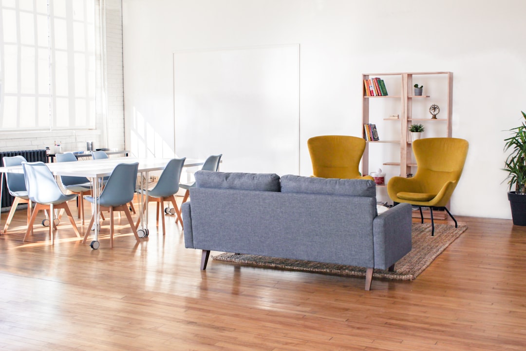 “Modern living space with bold yellow armchairs, a gray sofa, and minimalist furniture creating a stylish statement interior design.”