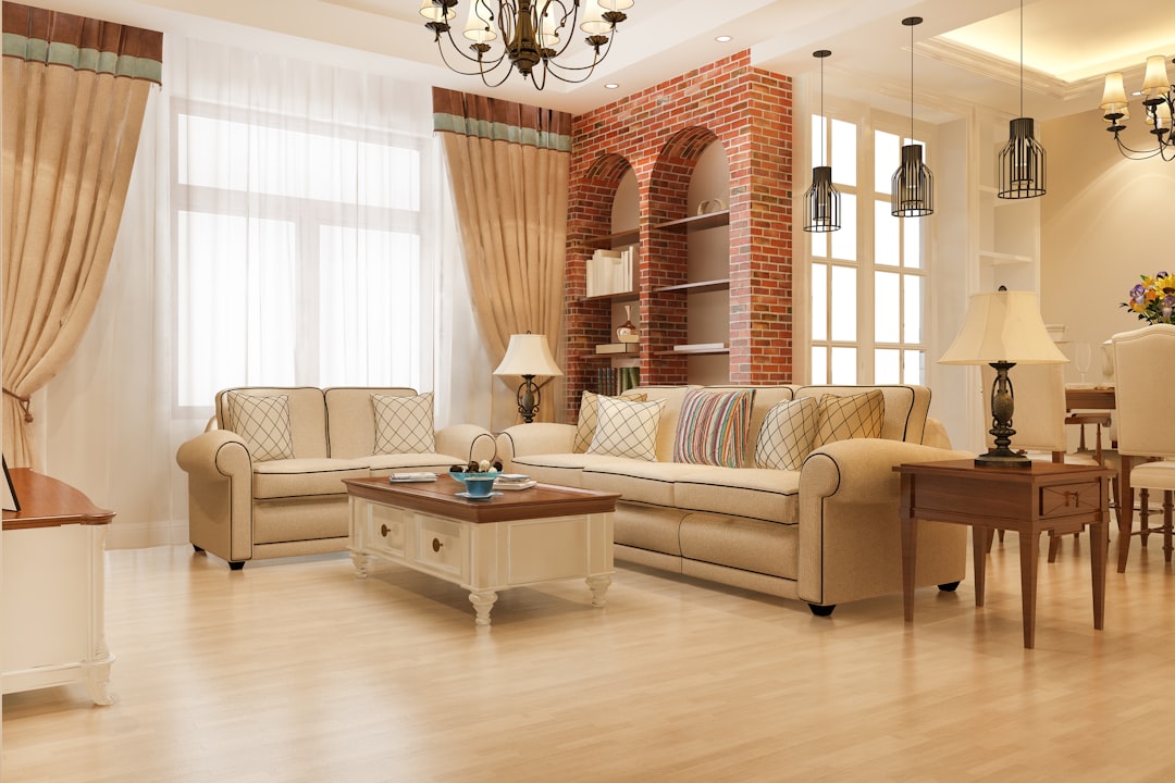Elegant living room with beige sofas, wooden coffee table, and brick accent wall blending modern and vintage decor