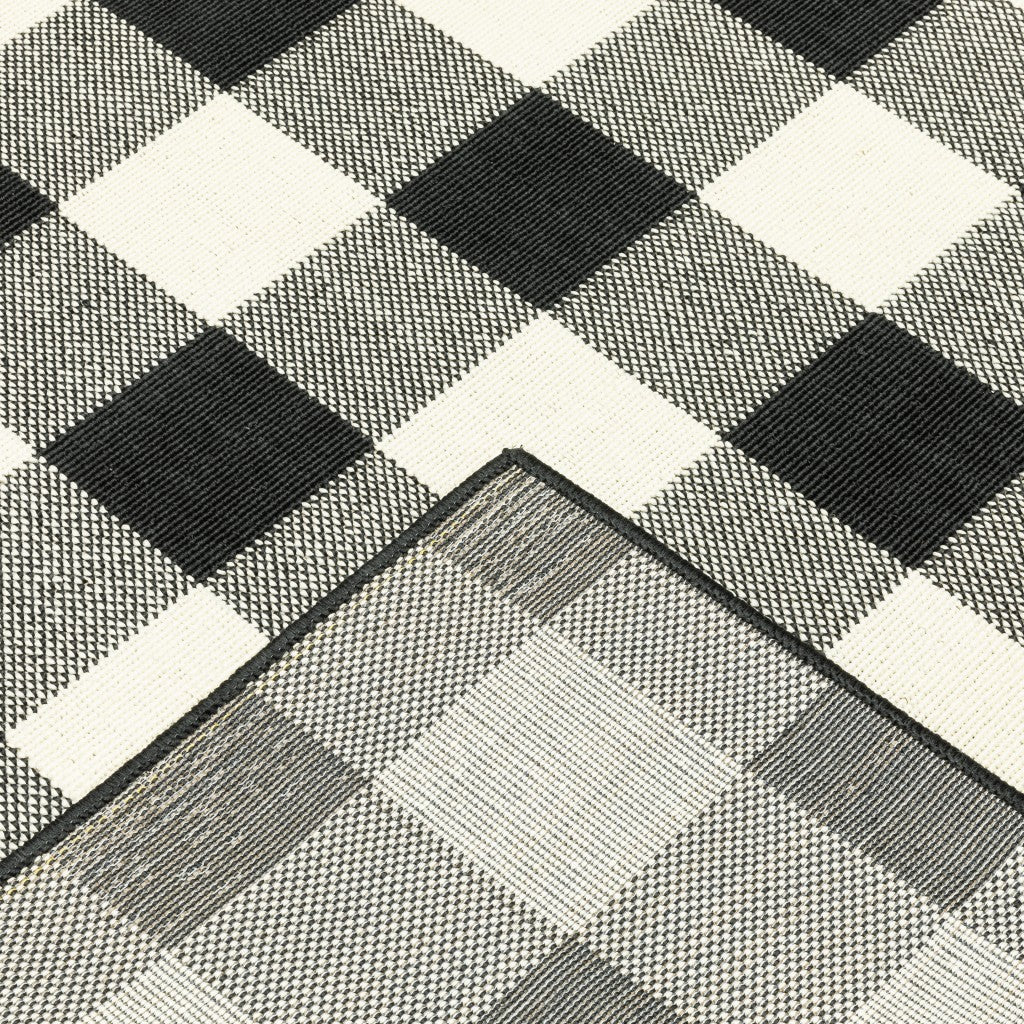 HomeRoots Polypropylene 2’x8’ Black and Ivory Gingham Indoor Outdoor Runner Rug