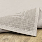 HomeRoots Polypropylene 7’x9’ Ivory and Gray Bordered Indoor Outdoor Area Rug