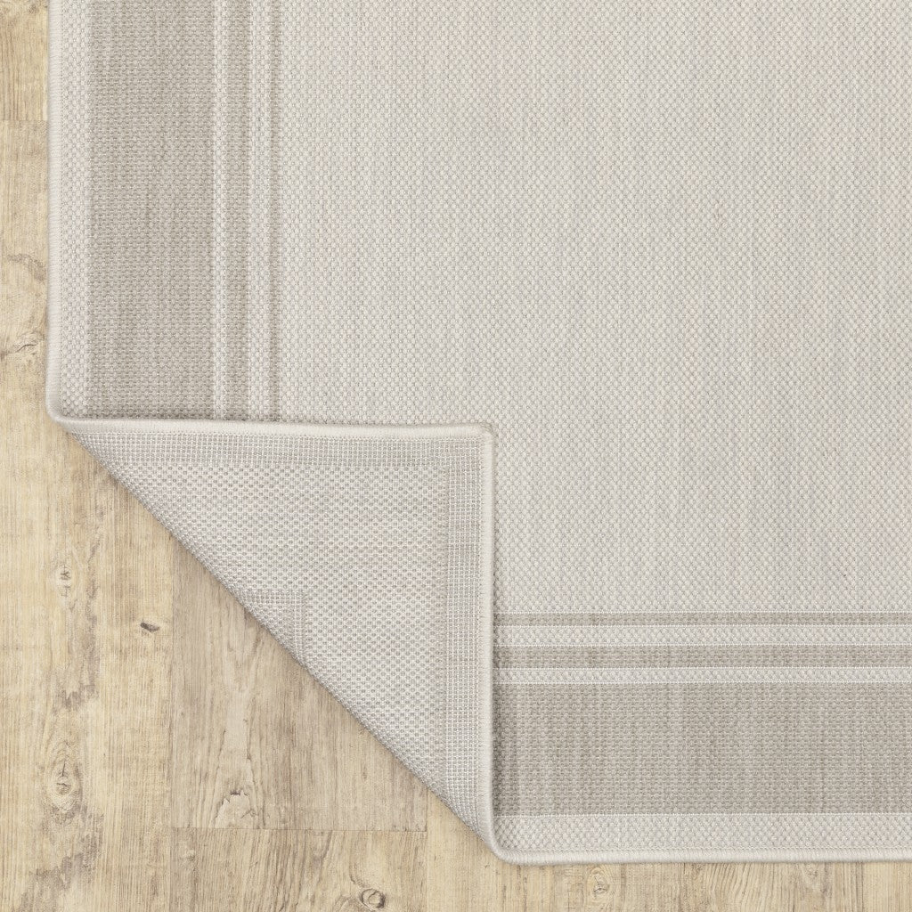 HomeRoots Polypropylene 7’x9’ Ivory and Gray Bordered Indoor Outdoor Area Rug
