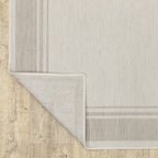 HomeRoots Polypropylene 7’x9’ Ivory and Gray Bordered Indoor Outdoor Area Rug