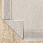 HomeRoots Polypropylene 7’x9’ Ivory and Gray Bordered Indoor Outdoor Area Rug