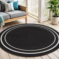 4 Black And Ivory Round Indoor Outdoor Area Rug