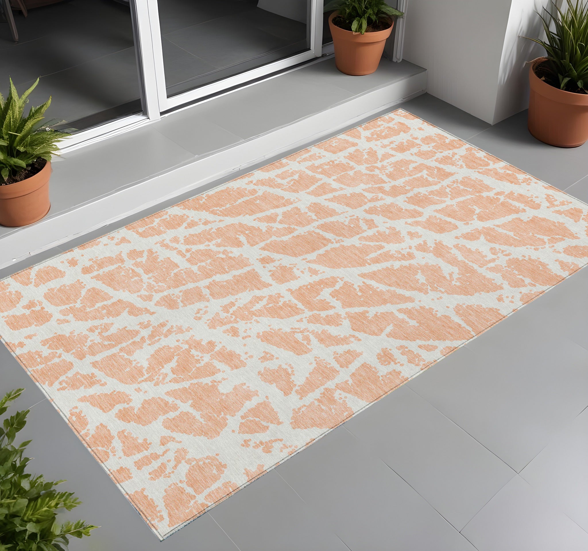 2' X 3' Peach And Ivory Abstract Washable Non Skid Indoor Outdoor Area Rug