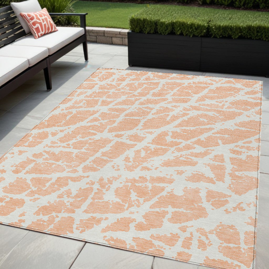 5' X 8' Peach And Ivory Abstract Washable Non Skid Indoor Outdoor Area Rug