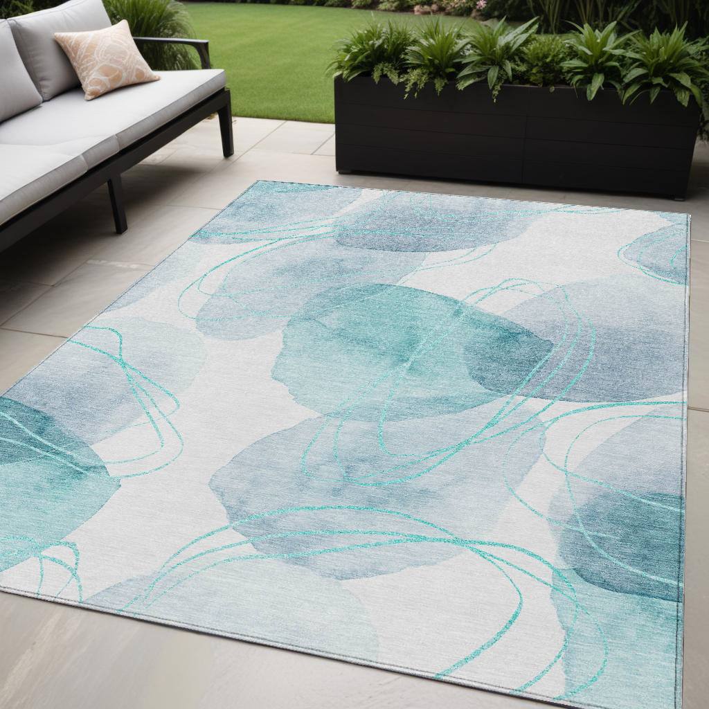 5' X 8' Teal And Ivory Abstract Washable Non Skid Indoor Outdoor Area Rug