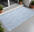 2' X 3' Blue And Ivory Geometric Washable Non Skid Indoor Outdoor Area Rug