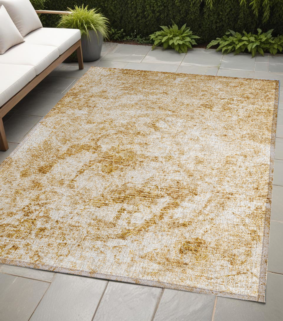 5' X 8' Cream And Gold Abstract Washable Non Skid Indoor Outdoor Area Rug