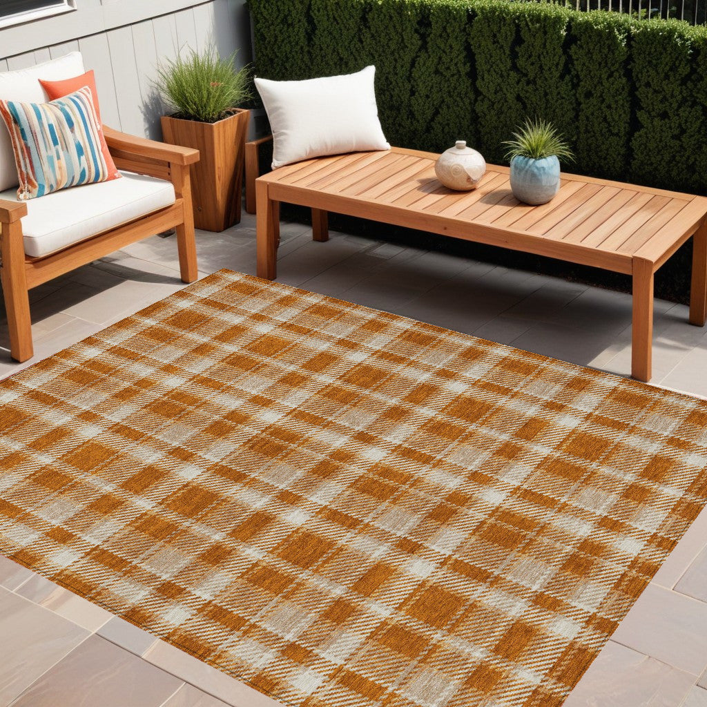 5' X 8' Orange And Ivory Plaid Washable Non Skid Indoor Outdoor Area Rug