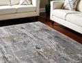 7' X 10' Gray Ivory and Gold Abstract Power Loom Area Rug With Fringe