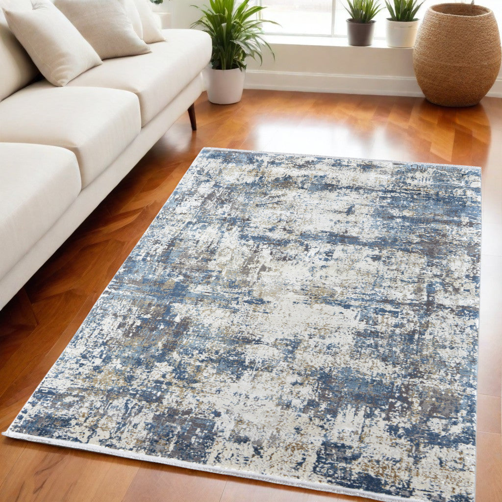 5' X 8' Ivory Tan and Blue Abstract Power Loom Area Rug With Fringe
