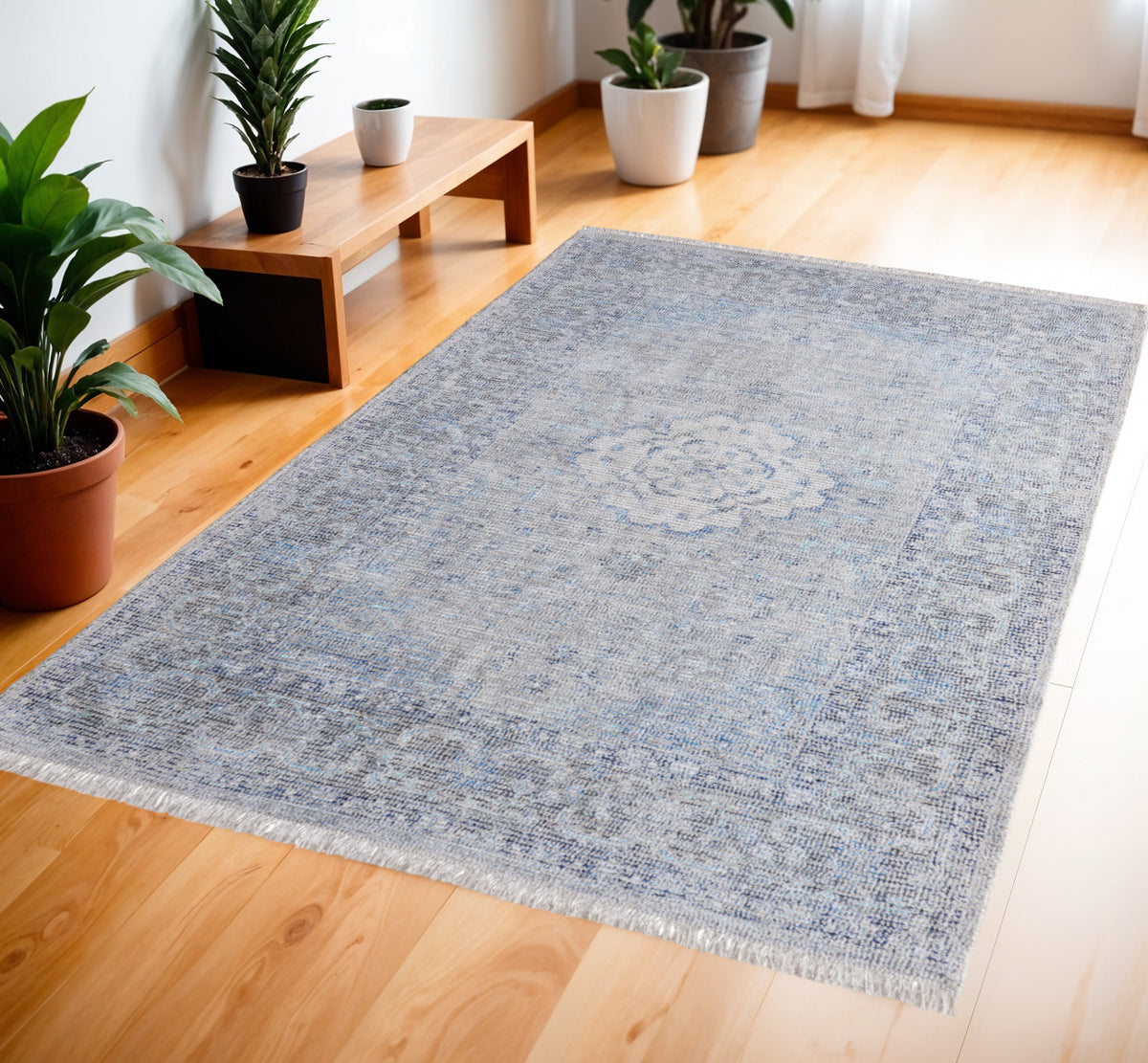 4' X 6' Gray Blue and Ivory Oriental Hand Woven Distressed Area Rug With Fringe