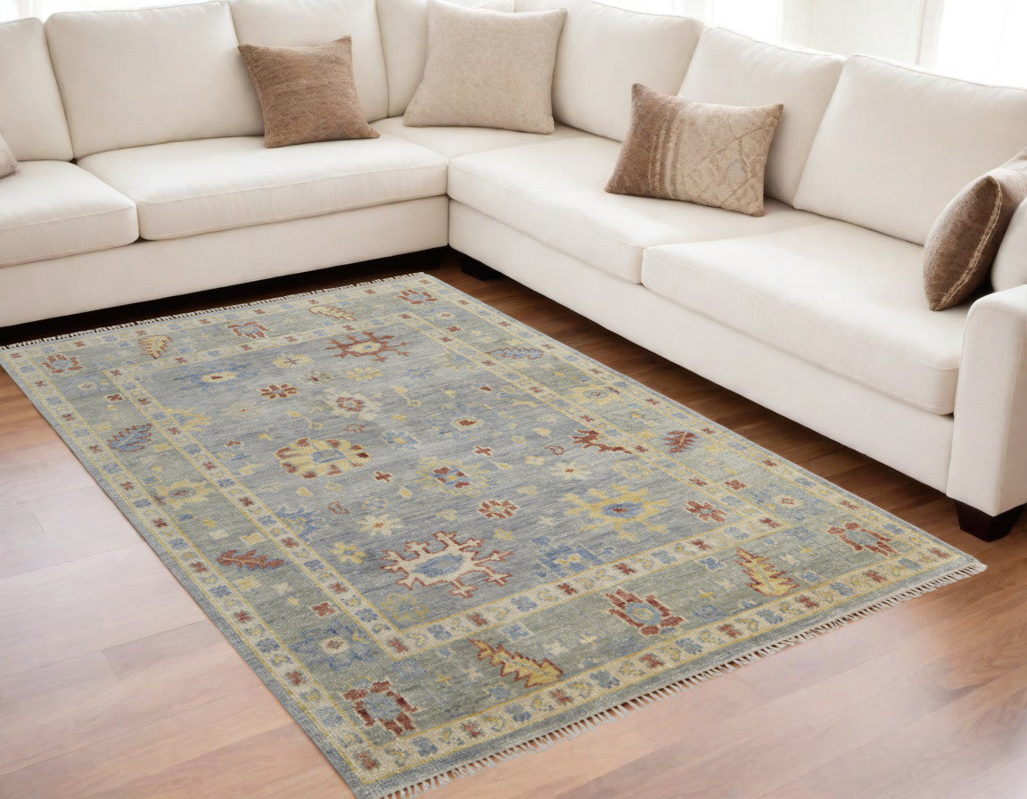5' X 8' Light Blue and Taupe Wool Floral Hand Knotted Area Rug With Fringe