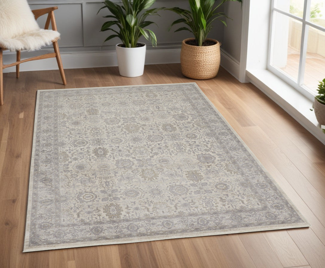 4' X 5' Gray and Ivory Oriental Power Loom Worn Faded Area Rug With Fringe