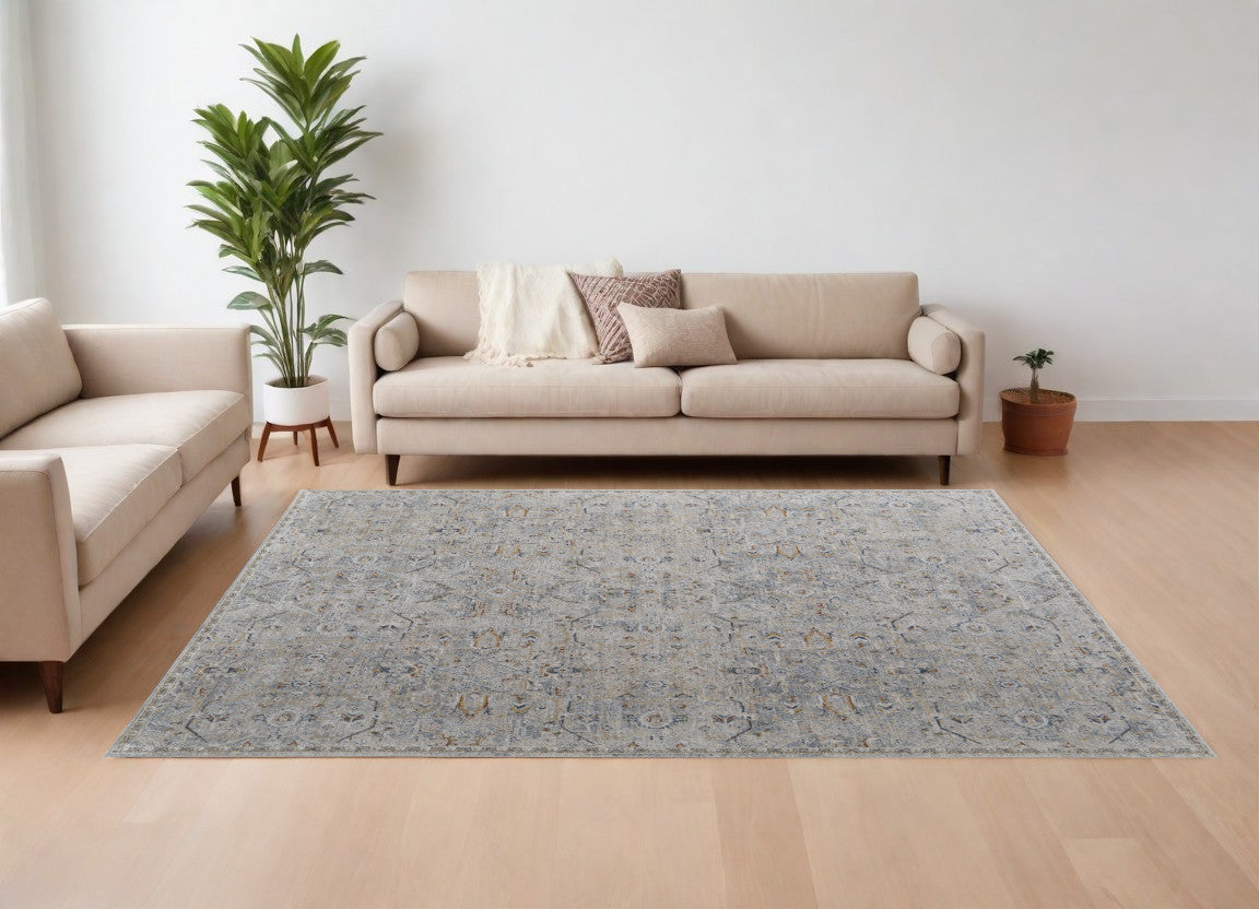 9' X 13' Ivory Tan and Blue Abstract Power Loom Worn Faded Area Rug With Fringe