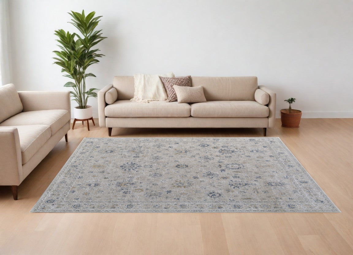 9' X 13' Ivory Taupe and Blue Floral Power Loom Worn Faded Area Rug With Fringe