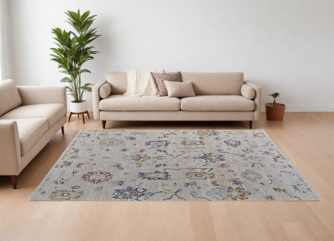 7' X 10' Ivory Blue and Gold Floral Power Loom Worn Faded Area Rug With Fringe