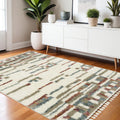 4' X 5' Tan Gray And Ivory Abstract Shag Distressed Area Rug With Fringe
