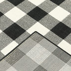 HomeRoots Polypropylene 7’x10’ Black and Ivory Gingham Indoor Outdoor Area Rug