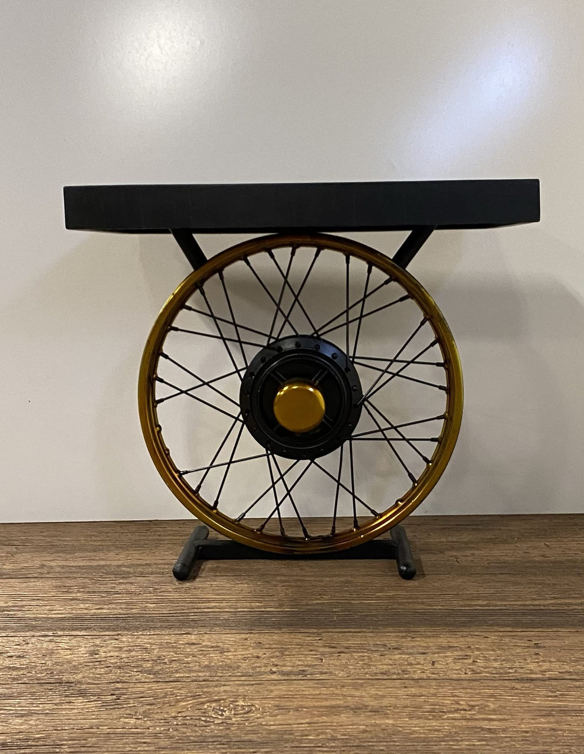 HomeRoots Wood and Metal Black and Gold Wheel Accent Table