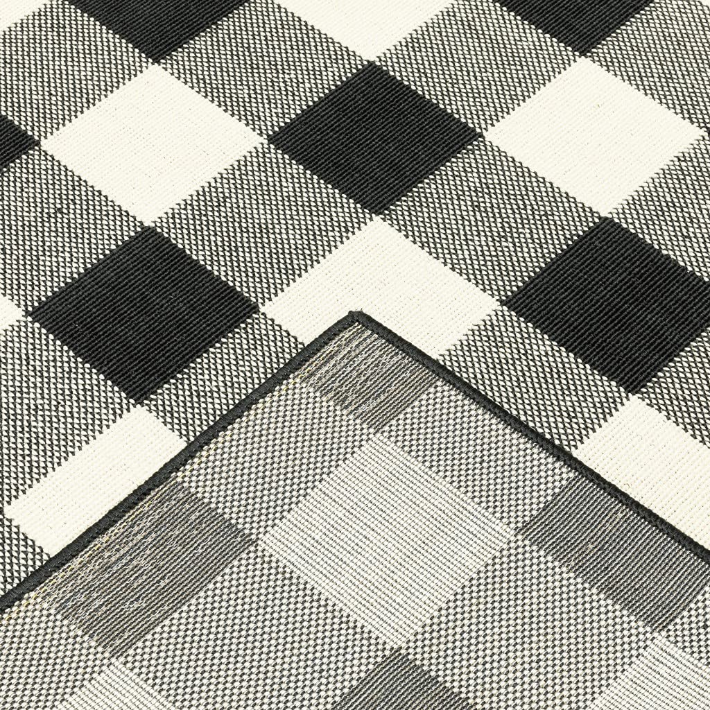 HomeRoots Polypropylene 2’x8’ Black and Ivory Gingham Indoor Outdoor Runner Rug