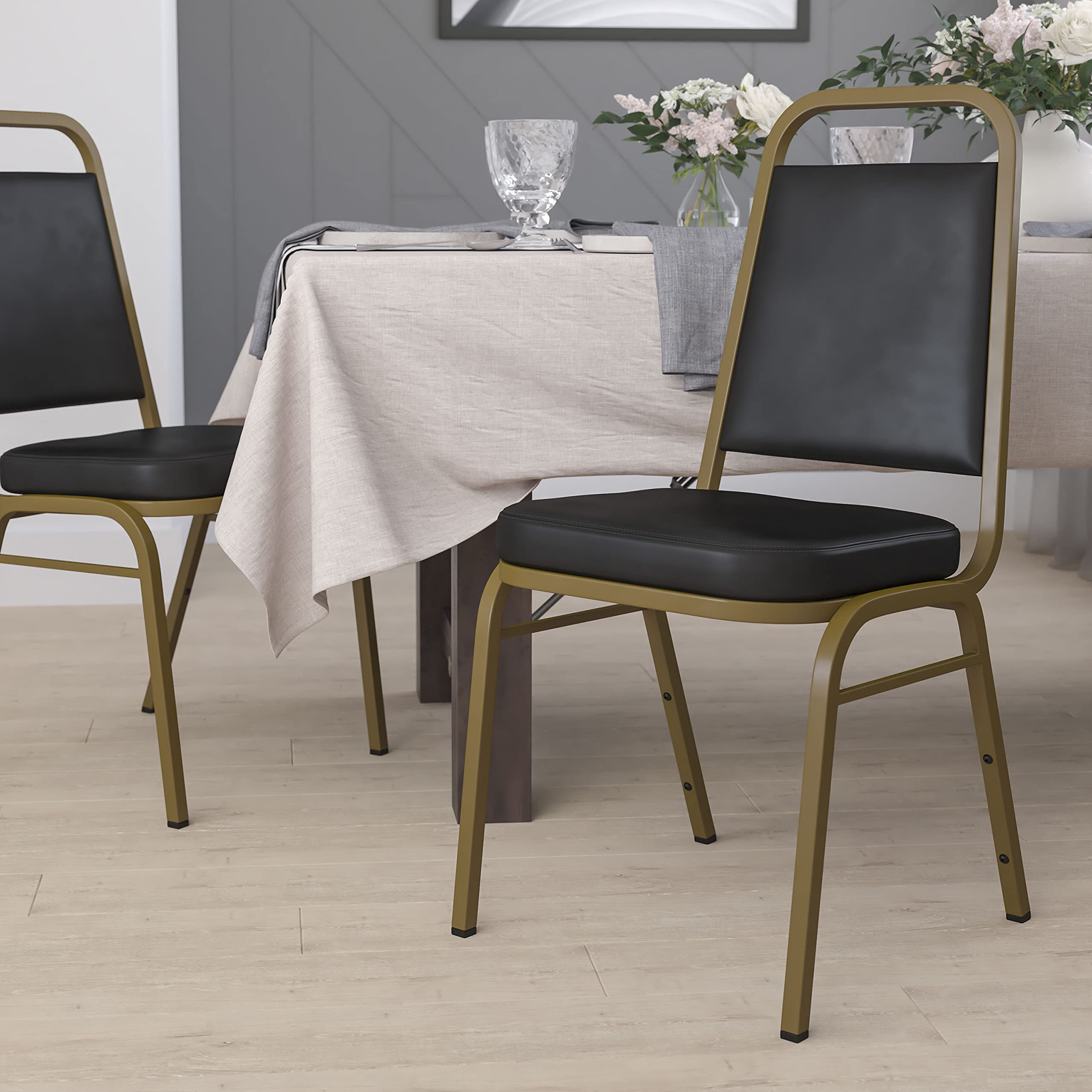 Flash Furniture HERCULES Series Trapezoidal Back Stacking Banquet Chair in Black Vinyl - Gold Frame